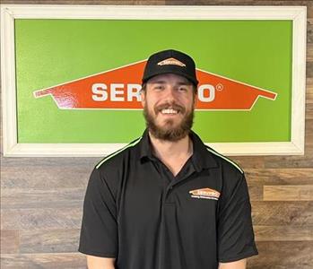 Alex standing in front of the servpro sign