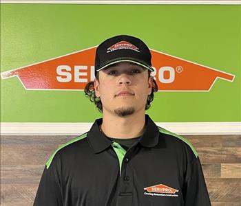 Cooper Archebelle standing in front of servpro sign